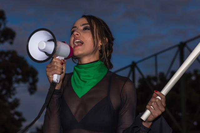 Attractive woman shouts with megaphone