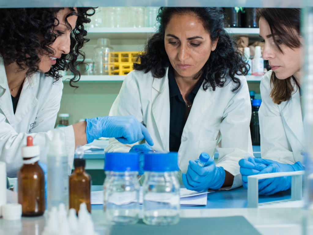 A group of female scientists, working at a fem-tech startup, doing lap work. 