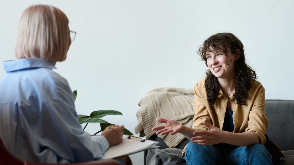 Young white woman talking to a female therapist