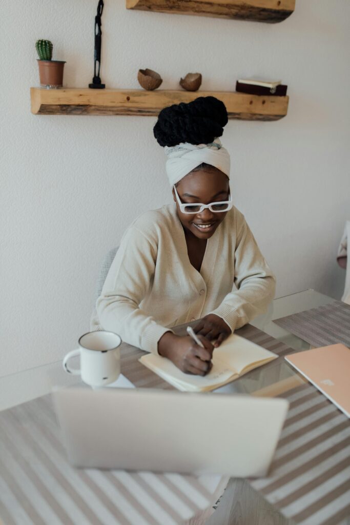 A young black woman therapist is working on her laptop. 