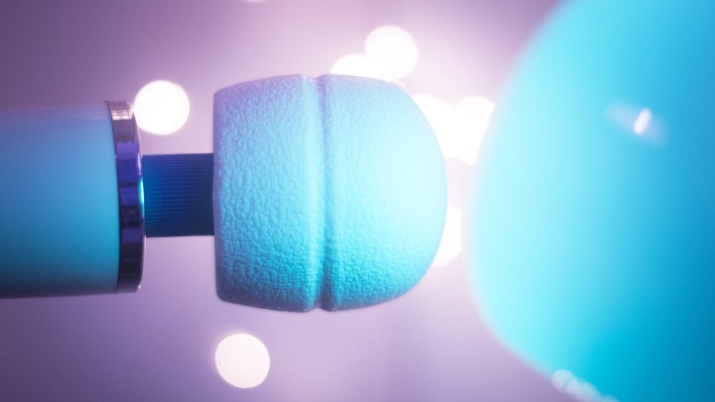 blue wand vibrator shown on grey-purple background