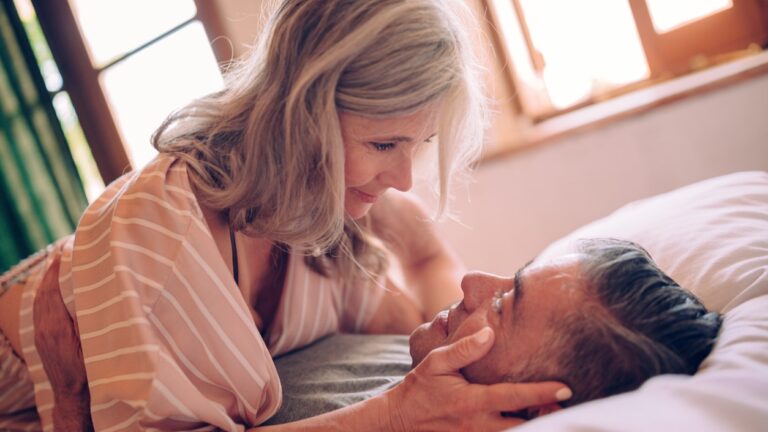 senior couple in bed looking into each others' eyes