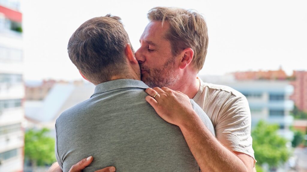 Mature gay couple embrace