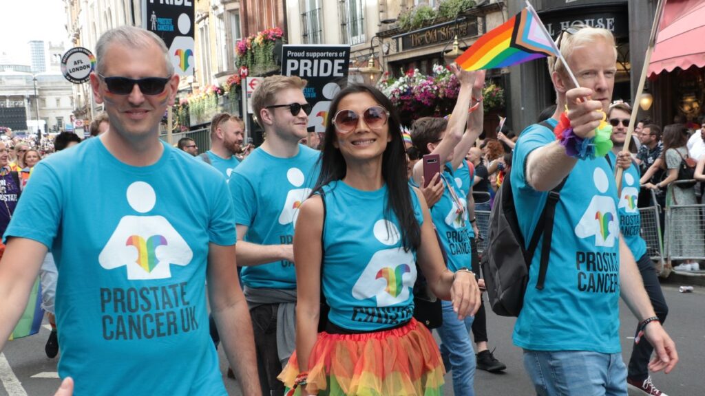 Pride parade with people wearing prostate cancer support shirts for better lgbt cancer care.