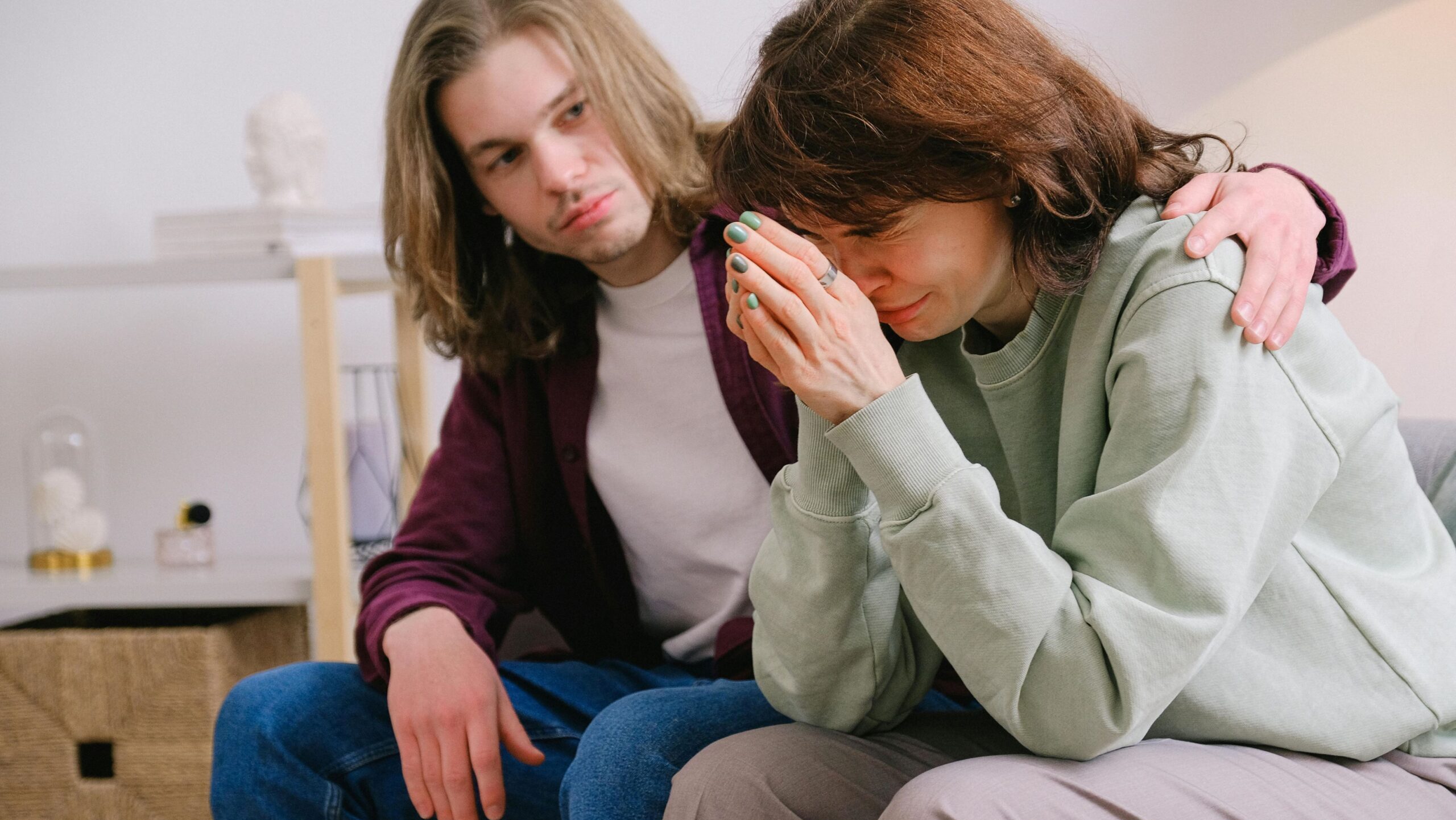 man comforting female partner