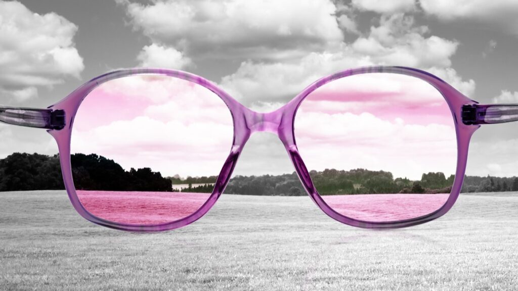 Rose colored glasses give a pink tint to a grey world