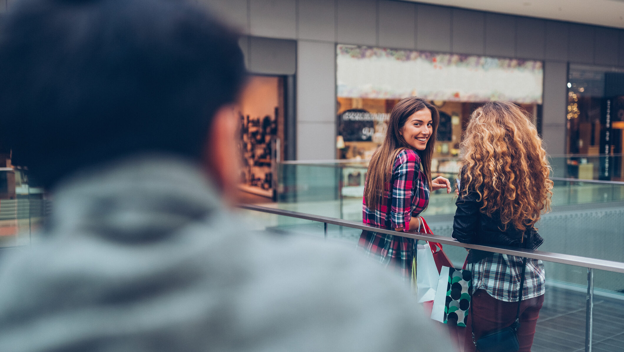 young woman flirting in a shopping center