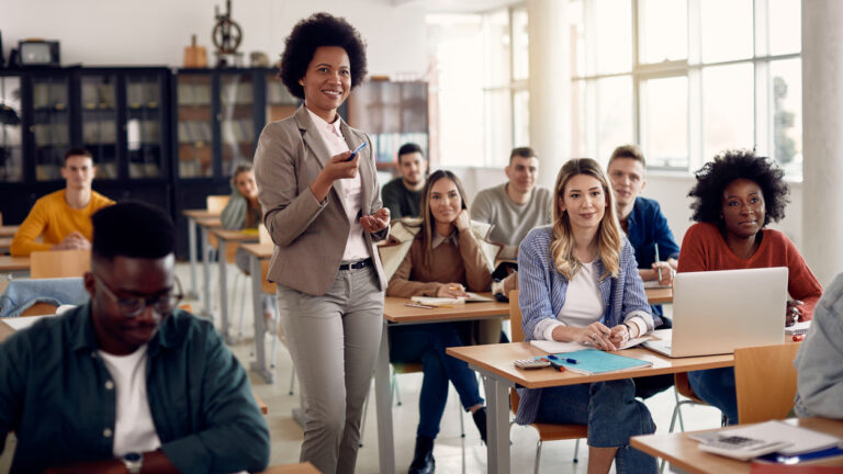 Happy African American teacher giving lecture to her students at university classroom.