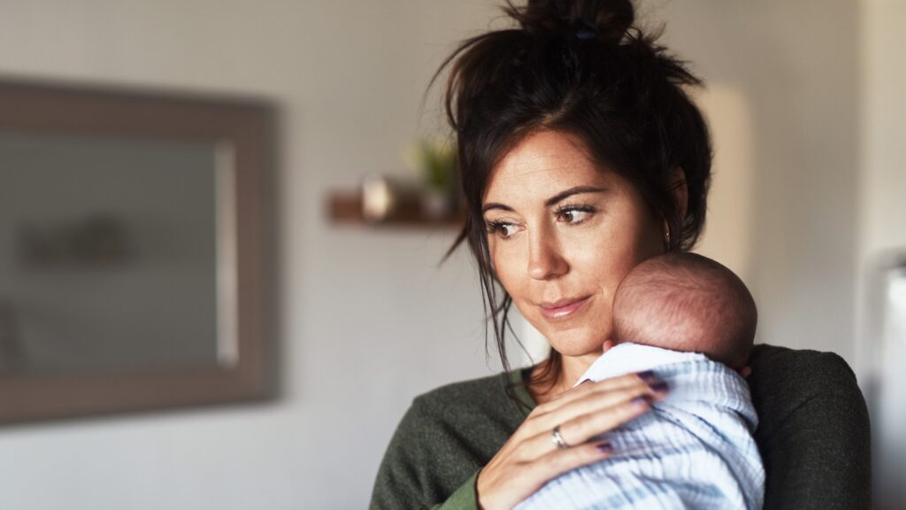 woman holds newborn baby
