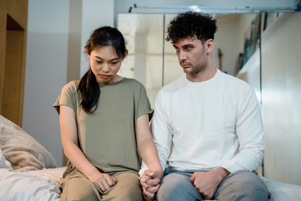 man looking at woman who looks upset
